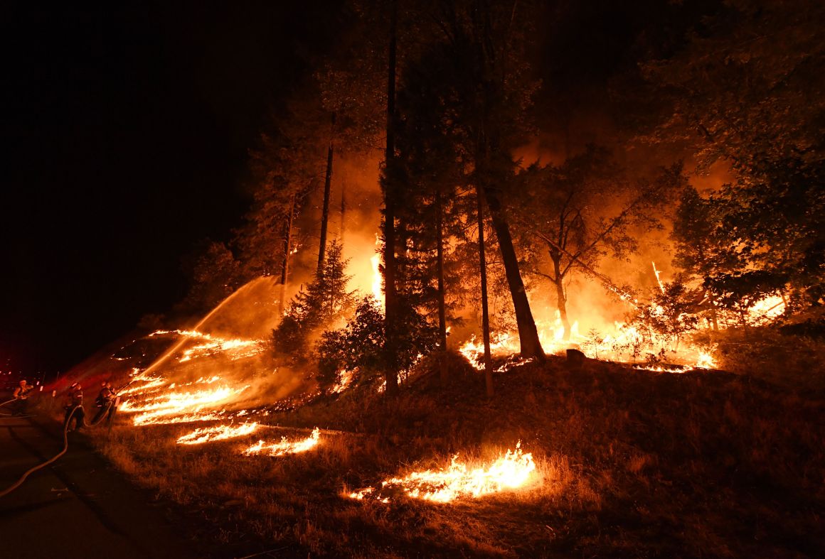 Firefighters try to control a back burn as the Carr Fire spreads toward the towns of Douglas City and Lewiston near Redding, California, on July 31st, 2018.