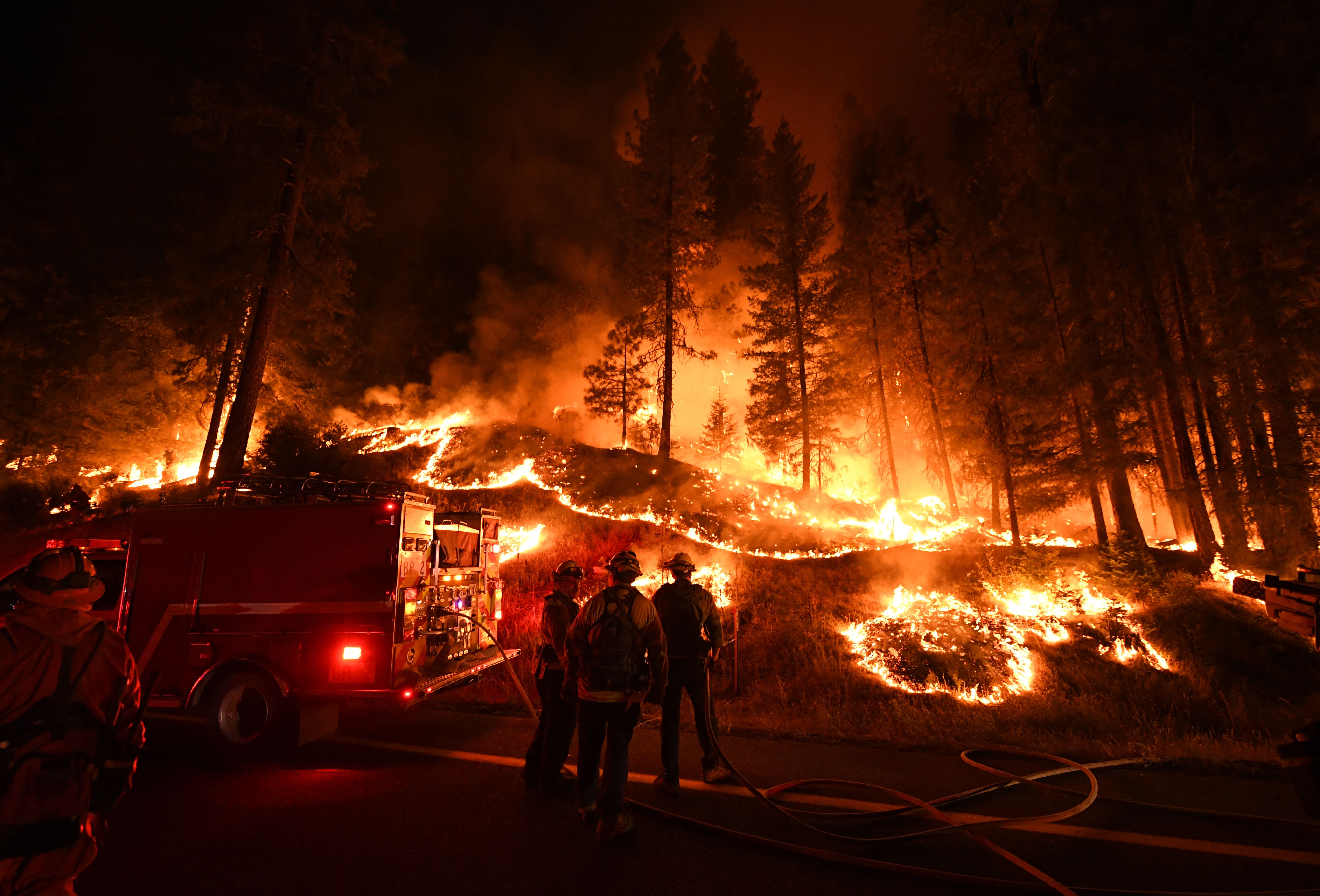 Firefighters try to control a back burn as they battle the Carr Fire near Redding, California, on July 31st, 2018.