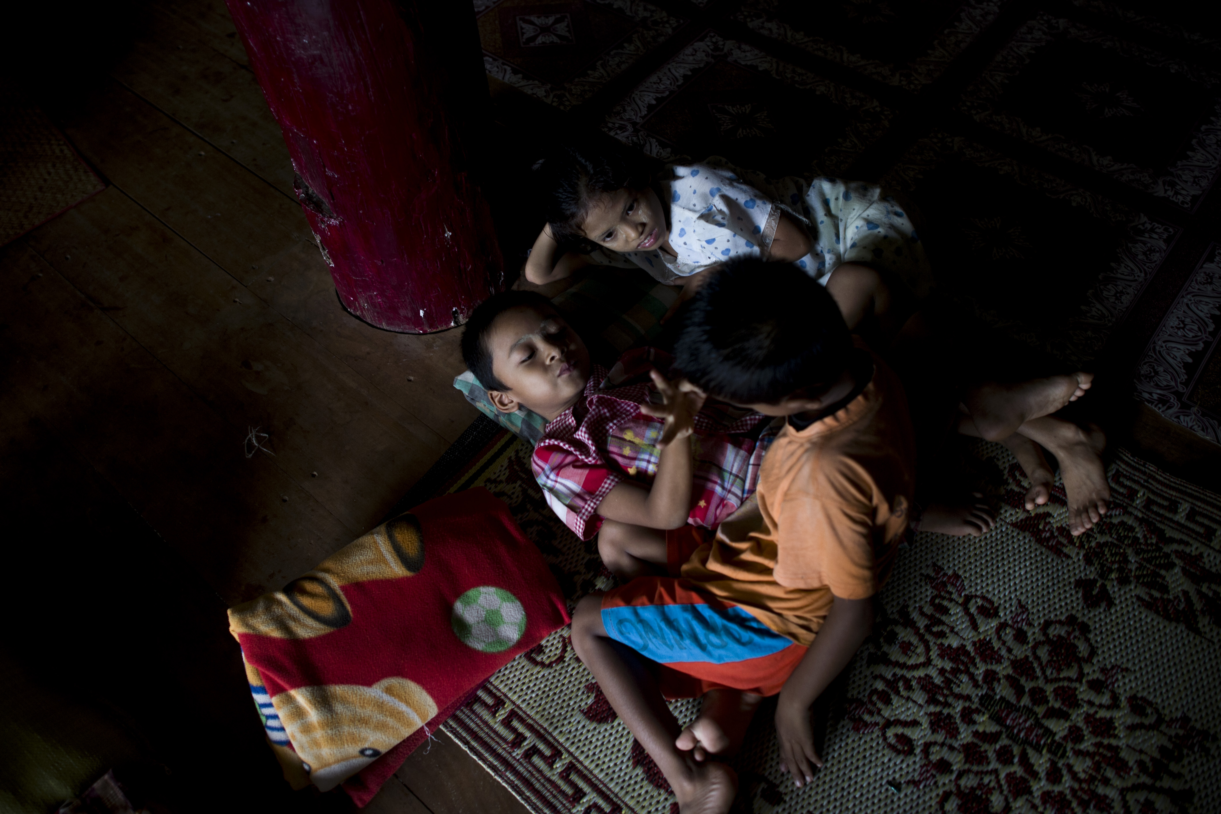 Children rest as residents displaced from floods take shelter in a monastery compound in Madauk, Bago region, on August 2nd, 2018.