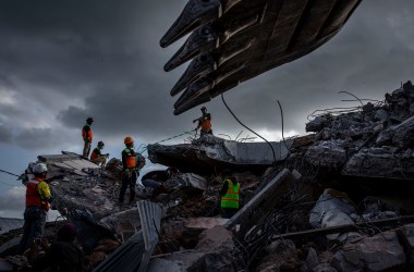 An Indonesian search-and-rescue team looks for victims under a collapsed mosque following an earthquake on August 7th, 2018, in Lombok Island, Indonesia. Nearly 100 people have been confirmed dead and at least 20,000 people have been left homeless after the 6.9 magnitude earthquake hit Lombok and neighboring Bali.