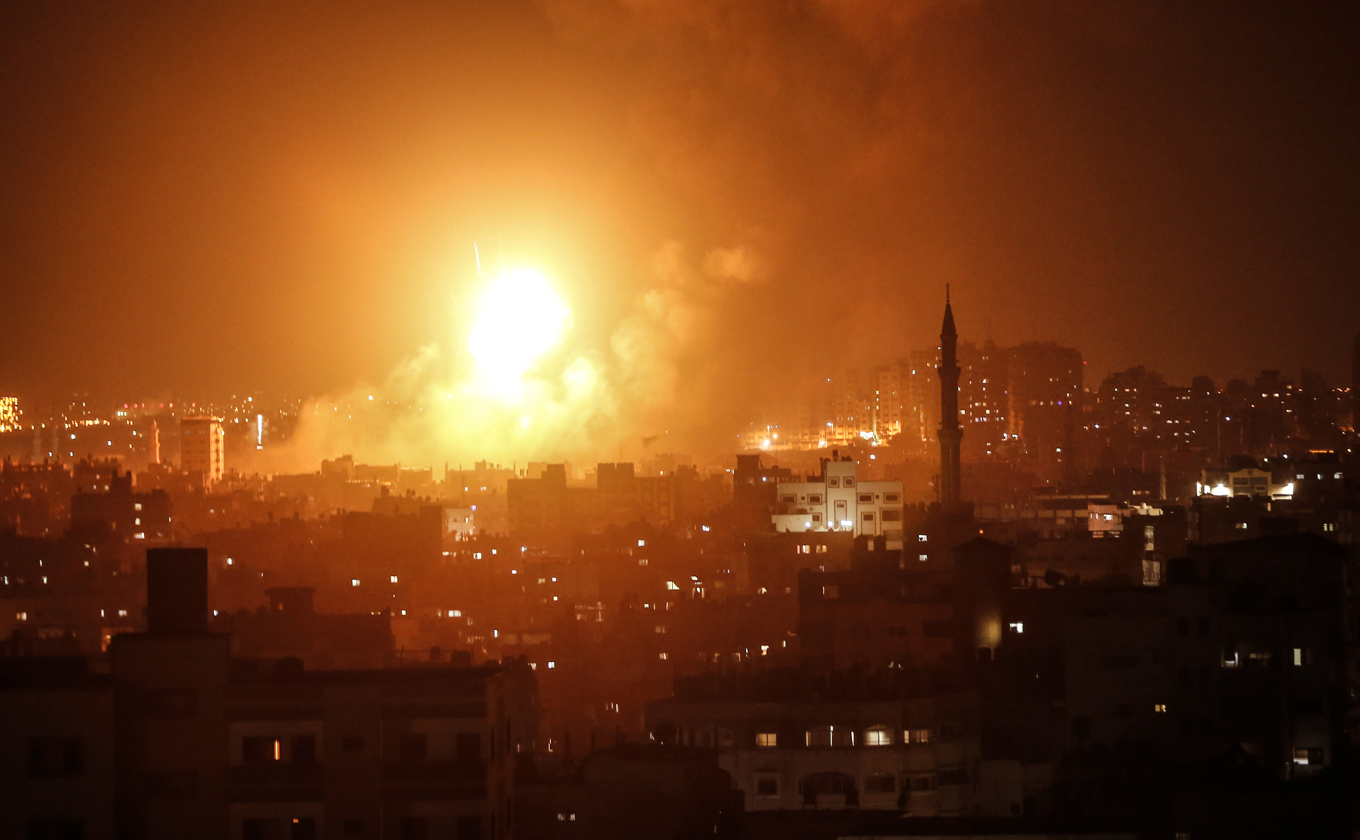 A fireball explodes over Gaza City during Israeli airstrikes on August 8th, 2018.