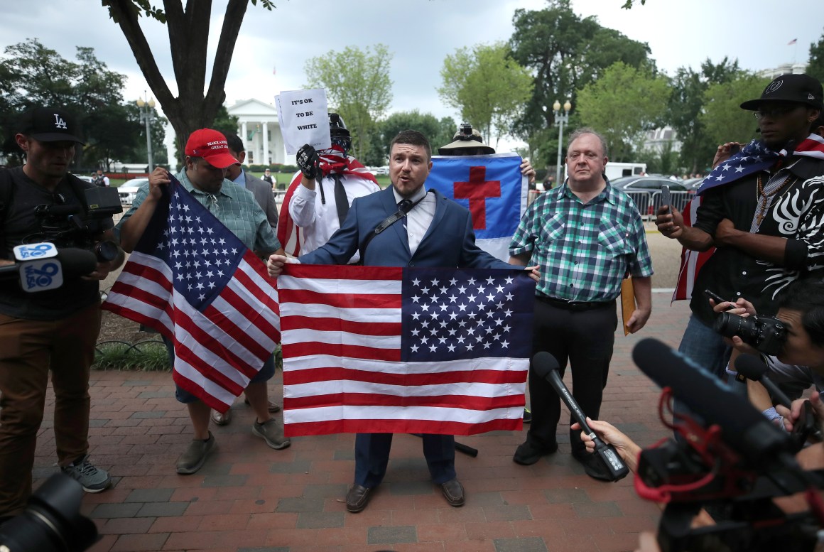 Jason Kessler (center), who organized the Unite the Right rally, speaks on August 12th, 2018, in Washington, D.C.