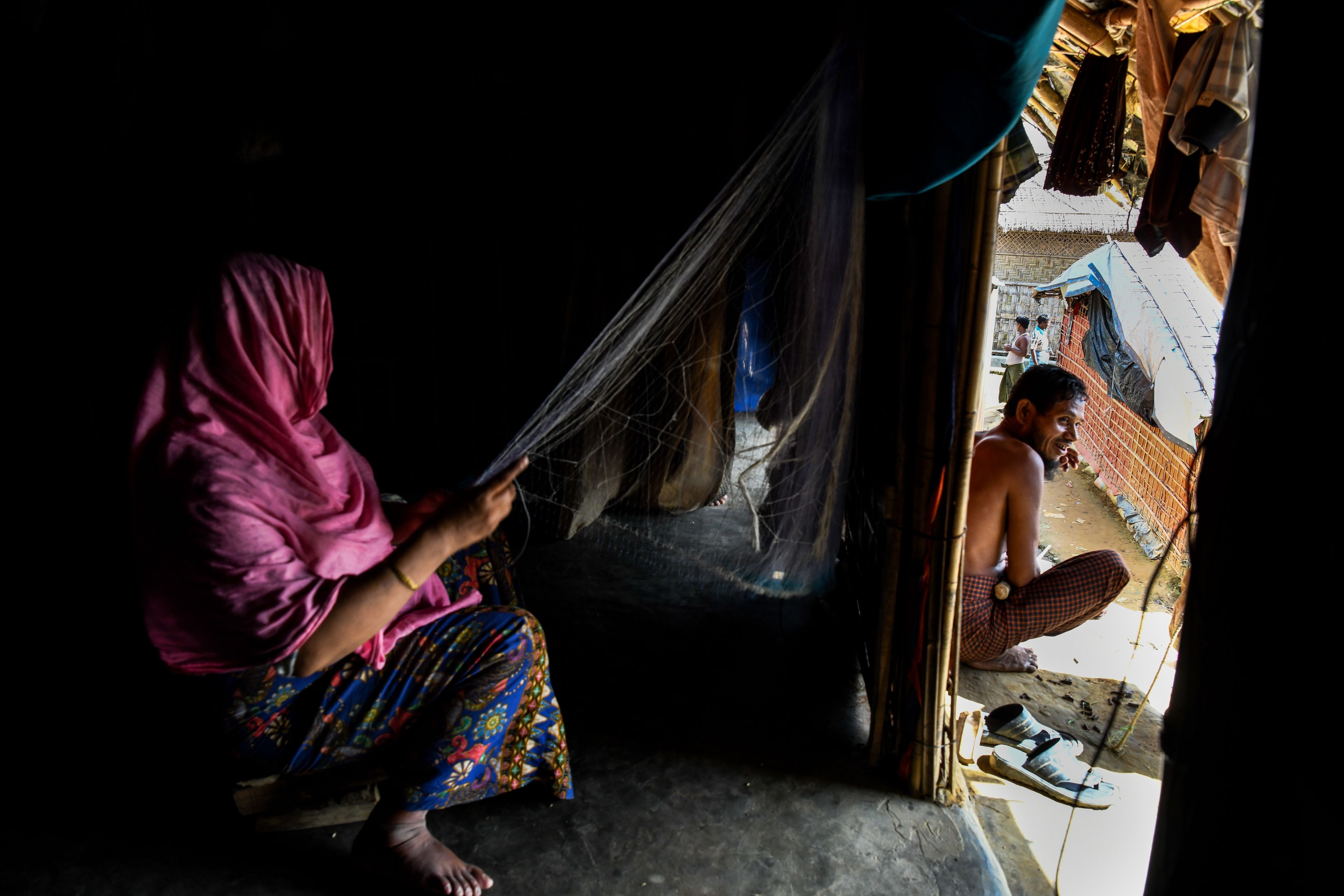 Rohingya refugee Toyoba, 40, makes a fishing net inside her tent in Kutupalong refugee camp in Ukhia on August 14th, 2018.