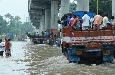 Indian commuters travel in a truck to a safer place as flood waters ravage the National Highway 47 in the Ernakulam district of Kochi, in the Southern Indian state of Kerala, on August 16th, 2018. According to the BBC, the death toll from floods in Kerala rose to over 100 on August 16th as torrential rainfall threatened new areas.