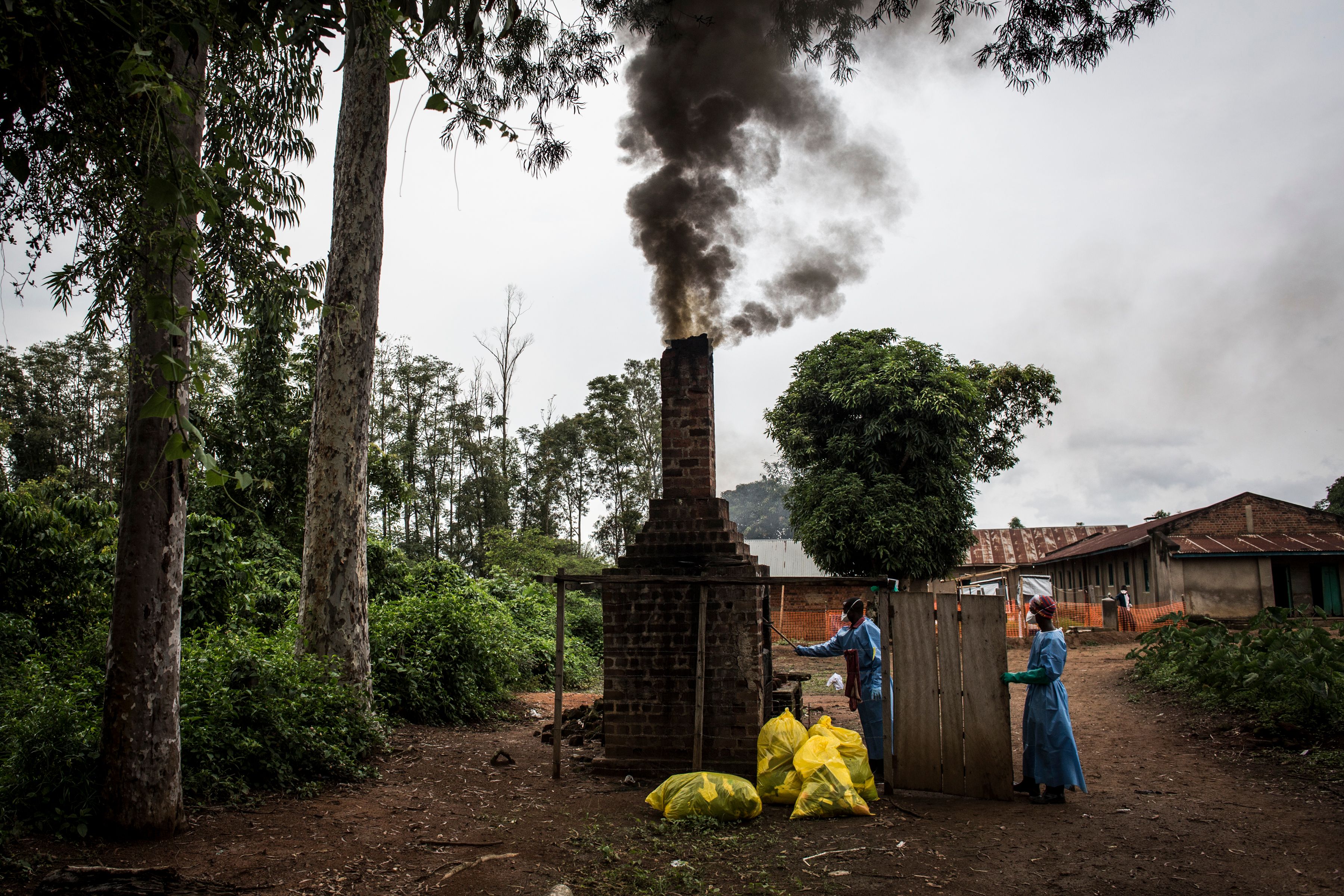 Health workers burn medical waste generated during care of patients with the Ebola virus, on August 21st, 2018, in Mangina, near Beni, in the North Kivu province.