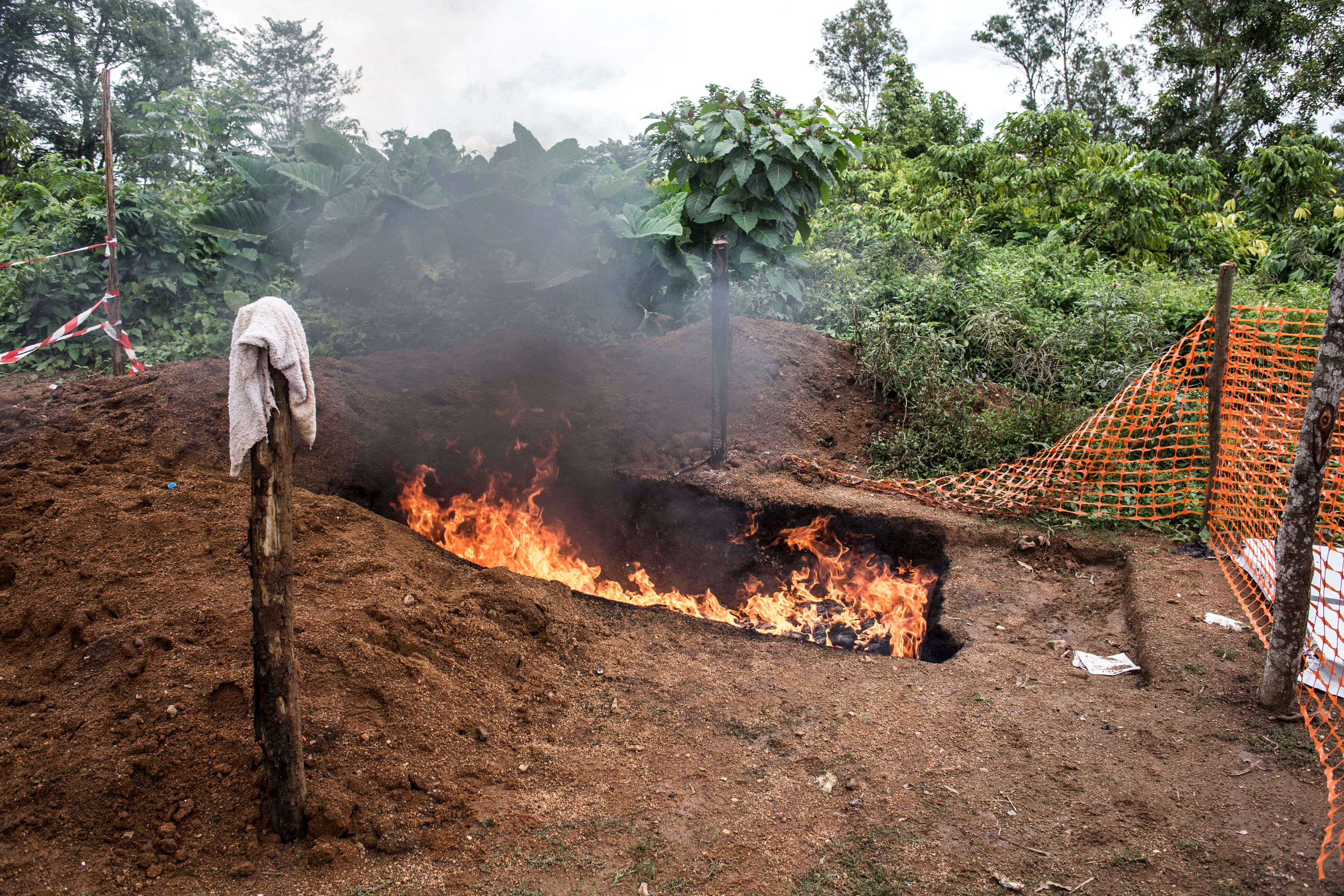 Health workers burn mattresses used by patients with the Ebola virus, on August 21st, 2018, in Mangina, near Beni, in the North Kivu province.