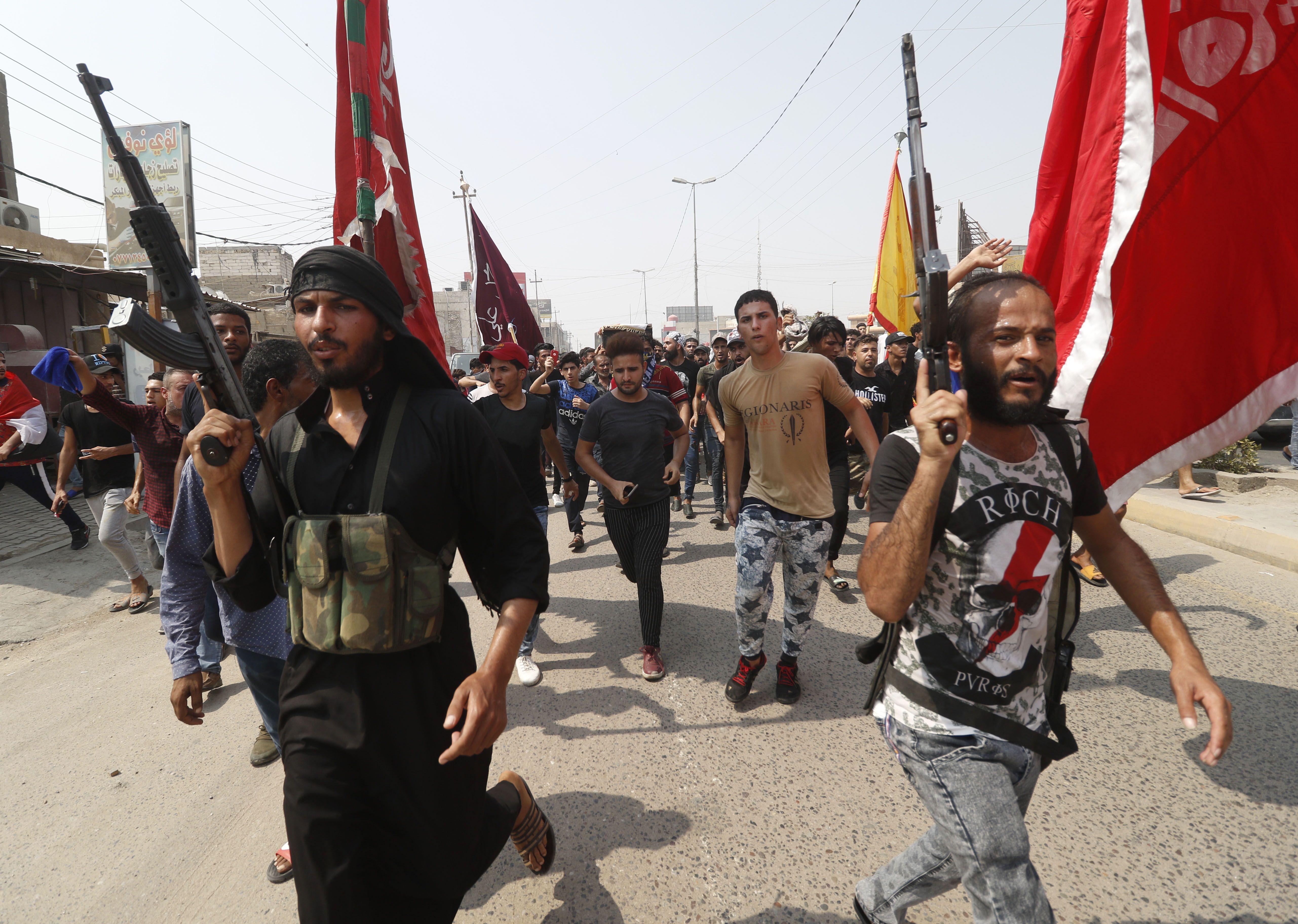 Armed Iraqi civilians attend a funeral on September 4th, 2018. Family and human rights activists claim the man was killed the previous day while demonstrating against the government and the lack of basic services.