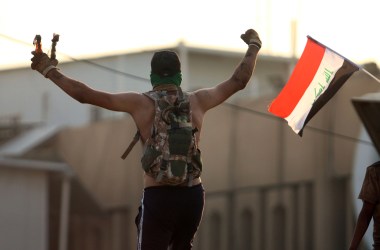 An Iraqi protester waves fire bombs during a protest outside the regional government headquarters in Basra on September 5th, 2018.