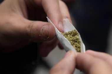 An activist rolls a joint during a protest against the prohibition of bearing a minimum dose of marijuana for personal use, in Bogota on September 6th, 2018.