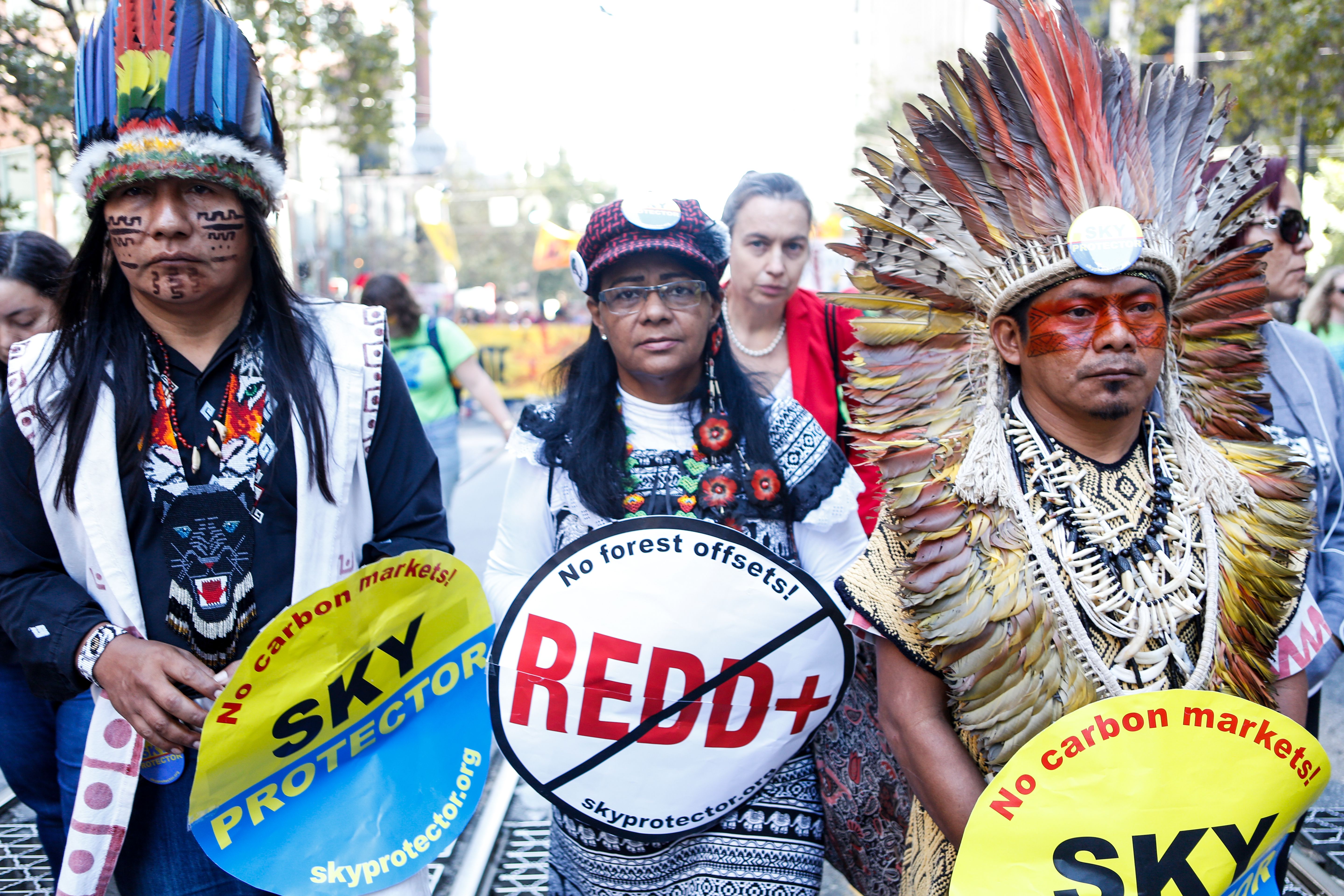 Chief Ninawá Inú Hunikui (right), president of the indigenous Federation of the Huni Kui People of the Brazilian Amazon, marches in San Francisco.