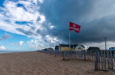 A No Swimming flag flies on the beach in Kill Devil Hills in the Outer Banks of North Carolina.