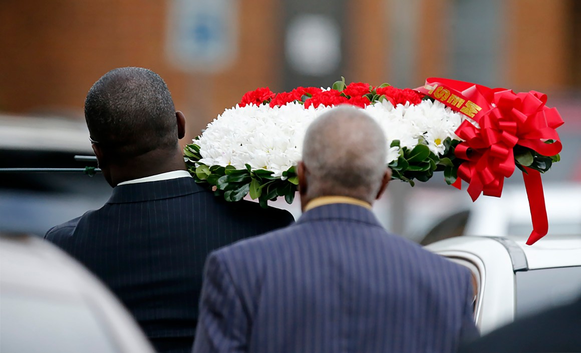 Mourners carry a wreath of flowers at the funeral service for Botham Shem Jean at the Greenville Avenue Church of Christ in Richardson, Texas, on September 13th, 2018.