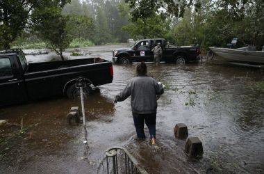 A resident walks from her flooded house toward the crew of the Cajun Navy in Lumberton, North Carolina, on September 15th, 2018, in the wake of Hurricane Florence.