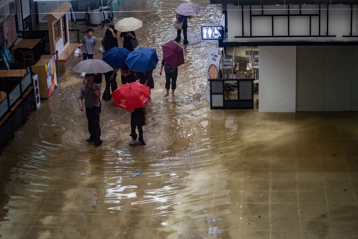 People walk through a flooded shopping mall in the Heng Fa Chuen district during Typhoon Mangkhut in Hong Kong, China, on September 16th, 2018.