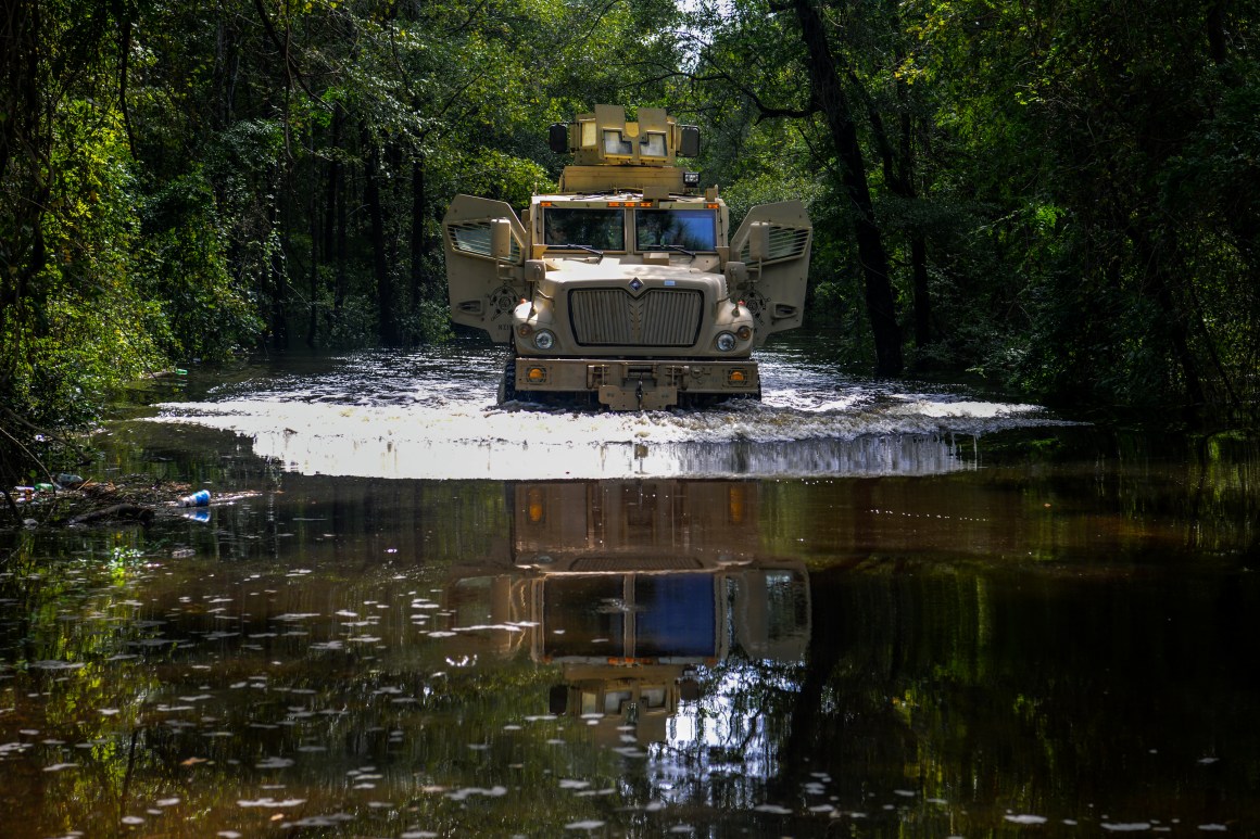 A tactical vehicle drives through floodwater in Florence County, South Carolina.