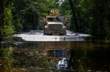 A tactical vehicle drives through floodwater in Florence County, South Carolina.