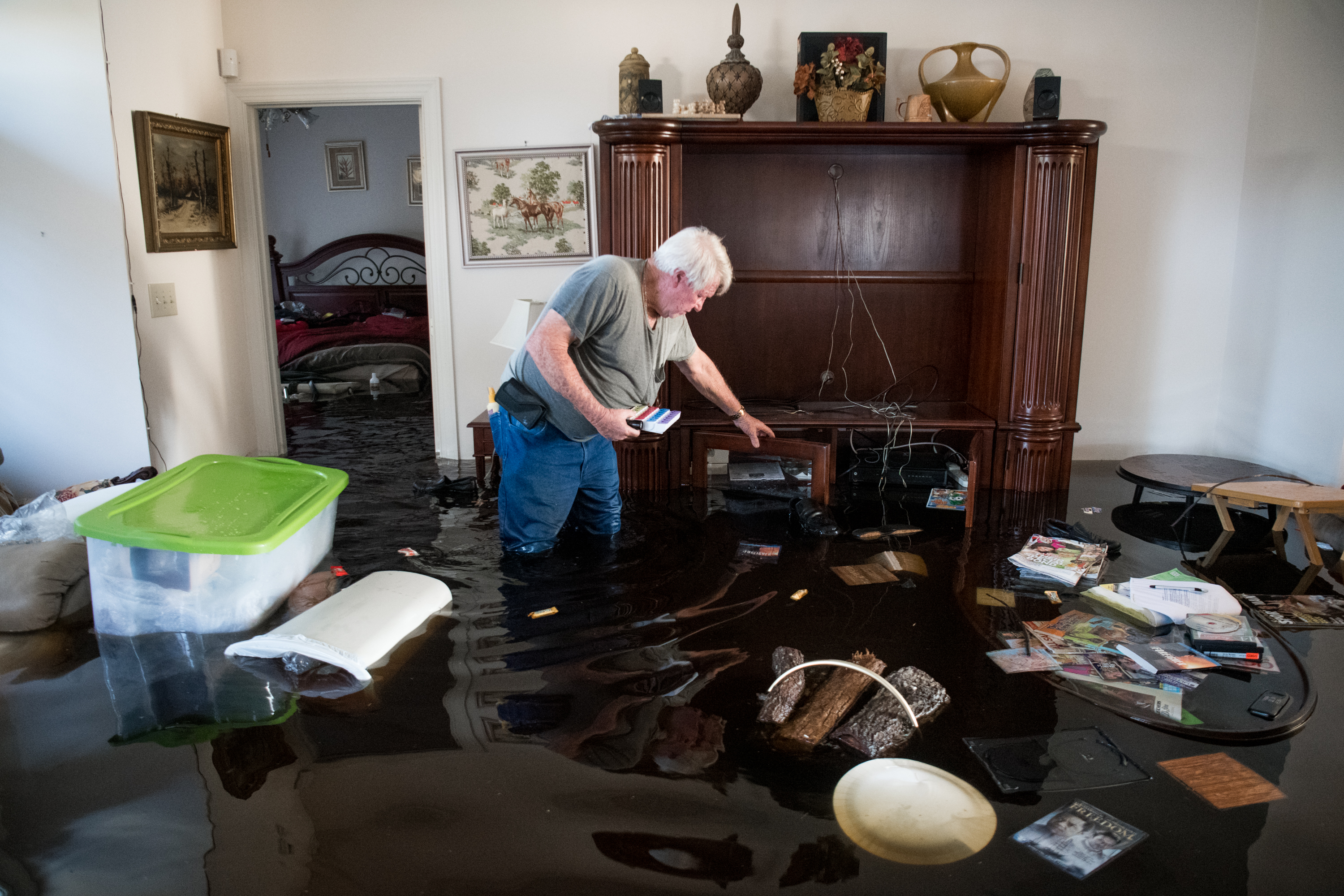 Billy Hardee removes valuables from his home as floodwater from Hurricane Florence rises at Aberdeen Country Club on September 20th, 2018, in Longs, South Carolina.