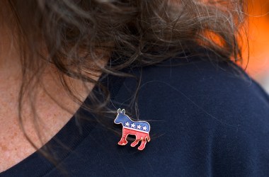 PHILADELPHIA, PA - SEPTEMBER 21: Donna Elms wears a Democrat donkey pin while lining up outside in advance of a campaign rally with former President Barack Obama, Pennsylvania Governor Tom Wolf, and Senator Bob Casey (D- PA) on September 21, 2018 in Philadelphia, Pennsylvania. Midterm election Day is November 6th.