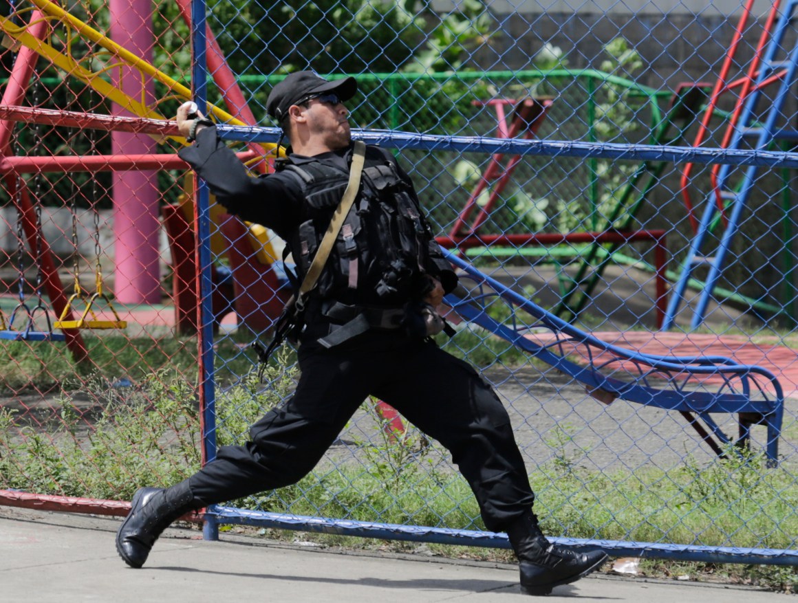 A riot policeman throws a sound grenade during clashes against protestors demonstrating against Nicaraguan President Daniel Ortega's government in Managua, on September 23rd, 2018.