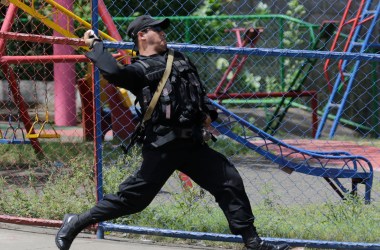 A riot policeman throws a sound grenade during clashes against protestors demonstrating against Nicaraguan President Daniel Ortega's government in Managua, on September 23rd, 2018.