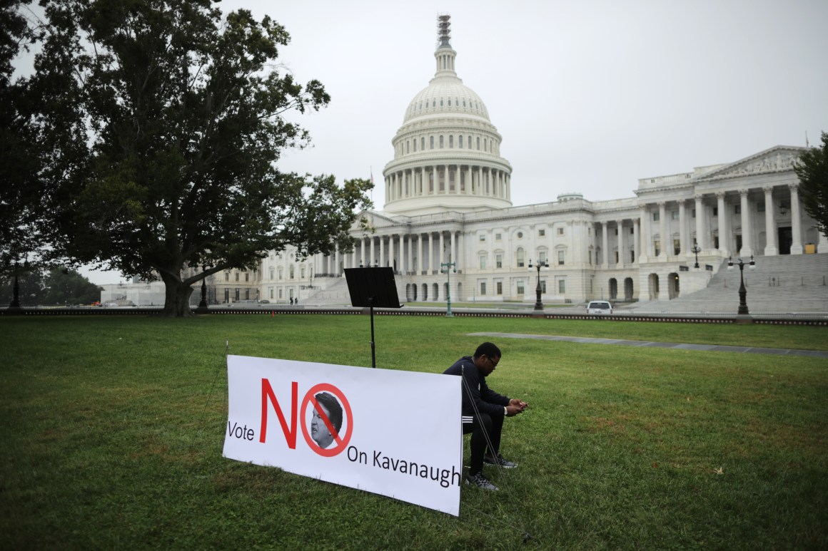 A student waits for fellow demonstrators for a rally on the U.S. Capitol East Lawn to protest the confirmation of Brett Kavanaugh on October 6th, 2018, in Washington, D.C.