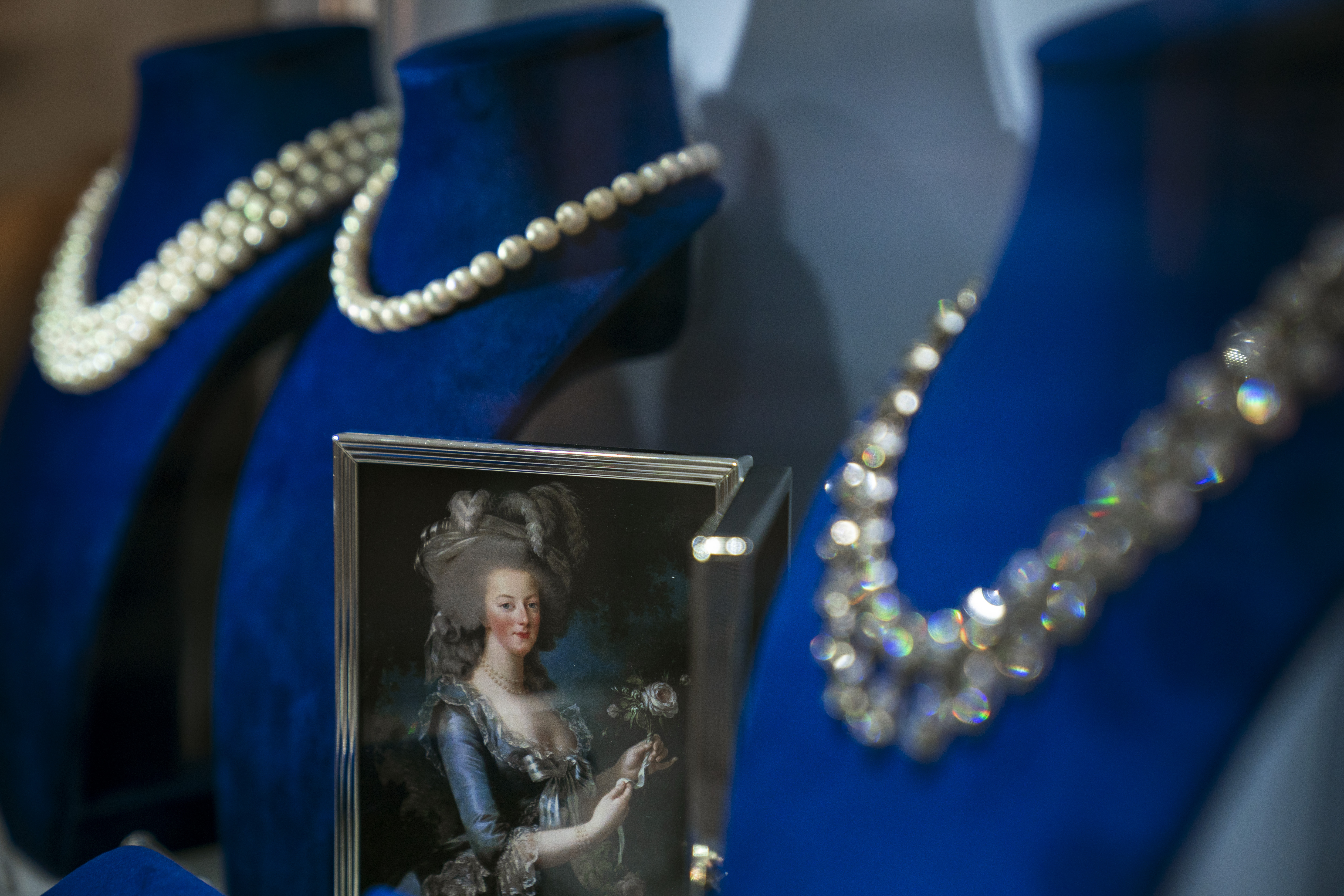 A photograph of French Queen Marie Antoinette is displayed among her jewelry at Sotheby's auction house, October 12th, 2018, in New York City. The collection of aristocratic jewels, belonging to the Bourbon-Parma family, is set to hit the auction block on November 14th.