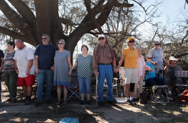 Worshipers attend Sunday service in the parking lot of Hiland Park Baptist Church on October 14th, 2018, in Panama City, Florida. The church building was damaged by Hurricane Michael.