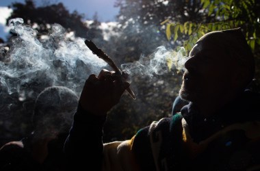 A man smokes marijuana during a legalization party at Trinity Bellwoods Park in Toronto, Ontario, on October 17th, 2018. Nearly a century of marijuana prohibition came to an end Wednesday as Canada became the first major Western nation to legalize and regulate its sale and recreational use. Scores of customers braved the cold for hours outside Tweed, a pot boutique in St John's, Newfoundland, that opened briefly at midnight, to buy their first grams of legal cannabis. In total, Statistics Canada says 5.4 million Canadians will buy cannabis from legal dispensaries in 2018—about 15 percent of the population. Around 4.9 million already smoke marijuana.