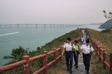 Police patrol ahead of Chinese President Xi Jinping's arrival for the official opening of the world's longest sea bridge on October 23rd, 2018, in Hong Kong. The bridge, which spans 34 miles, links Hong Kong, Macau, and Zhuhai on China's southern coast of Guangdong province, is set to open this week as part of Beijing's plan to merge 11 cities in its southern region into one megalopolis. Critics warn the bridge will increase China's influence over semi-autonomous Hong Kong.