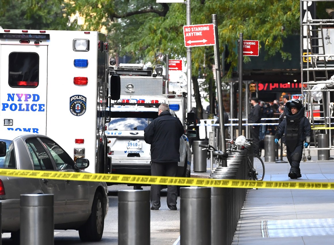 A New York Bomb Squad officer walks out of the Time Warner Building in Manhattan, New York, on October 24th, 2018, after a suspected explosive device was delivered to CNN's New York bureau. The bomb was addressed to John Brennan, President Barack Obama's former Central Intelligence Agency director and a critic of President Donald Trump. Bombs were also sent to Obama and other prominent Democrats like Hillary Clinton, Maxine Waters, and George Soros.