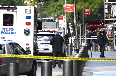 A New York Bomb Squad officer walks out of the Time Warner Building in Manhattan, New York, on October 24th, 2018, after a suspected explosive device was delivered to CNN's New York bureau. The bomb was addressed to John Brennan, President Barack Obama's former Central Intelligence Agency director and a critic of President Donald Trump. Bombs were also sent to Obama and other prominent Democrats like Hillary Clinton, Maxine Waters, and George Soros.