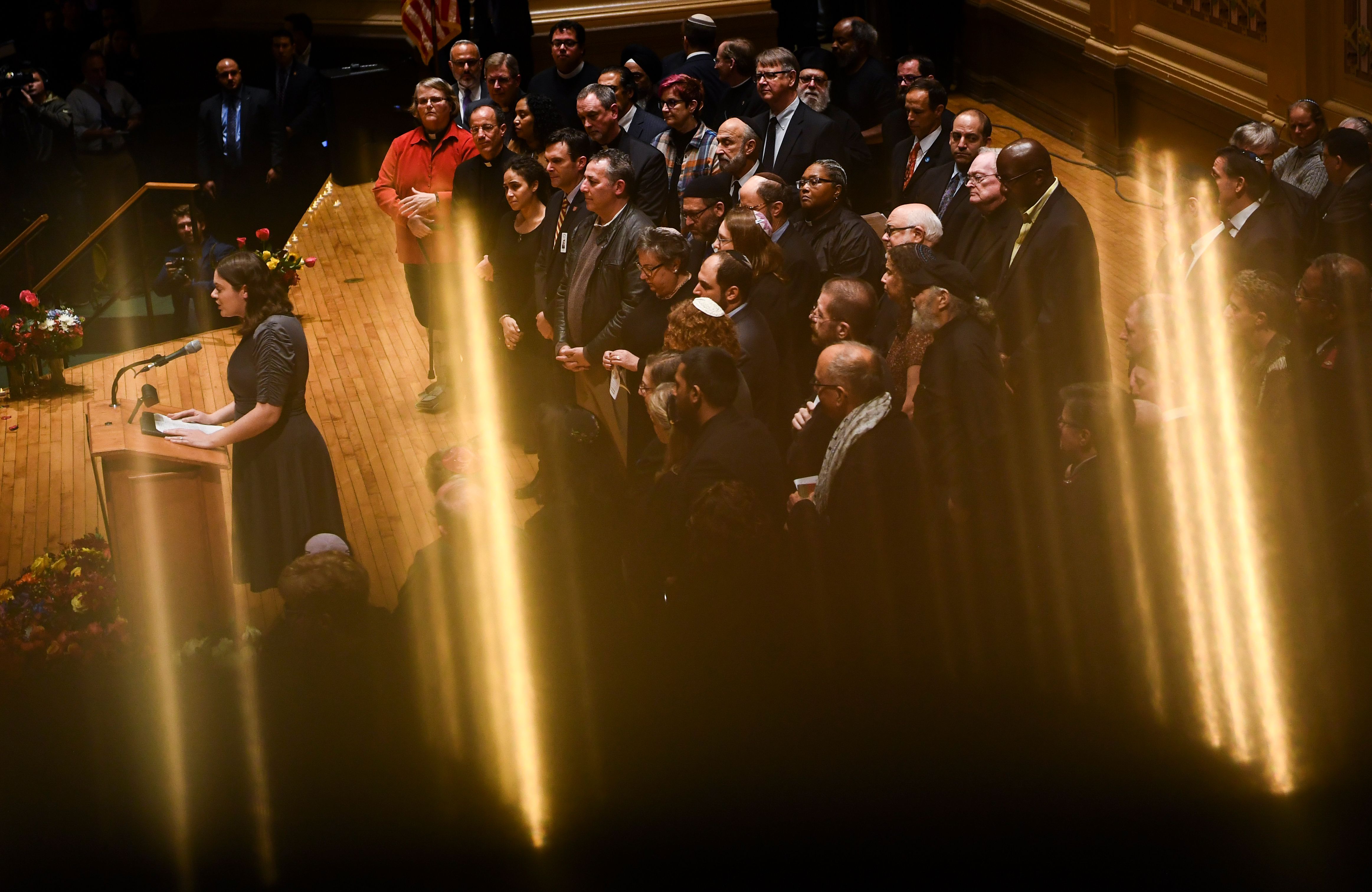 People take part in a vigil to remember the victims of the shooting at the Tree of Life synagogue at the Allegheny County Soldiers Memorial on October 28th, 2018, in Pittsburgh, Pennsylvania. The man suspected of bursting into a Pittsburgh synagogue during a baby-naming ceremony and gunning down 11 people, identified as 46-year-old Robert Bowers, has been charged with murder. Bowers reportedly yelled 