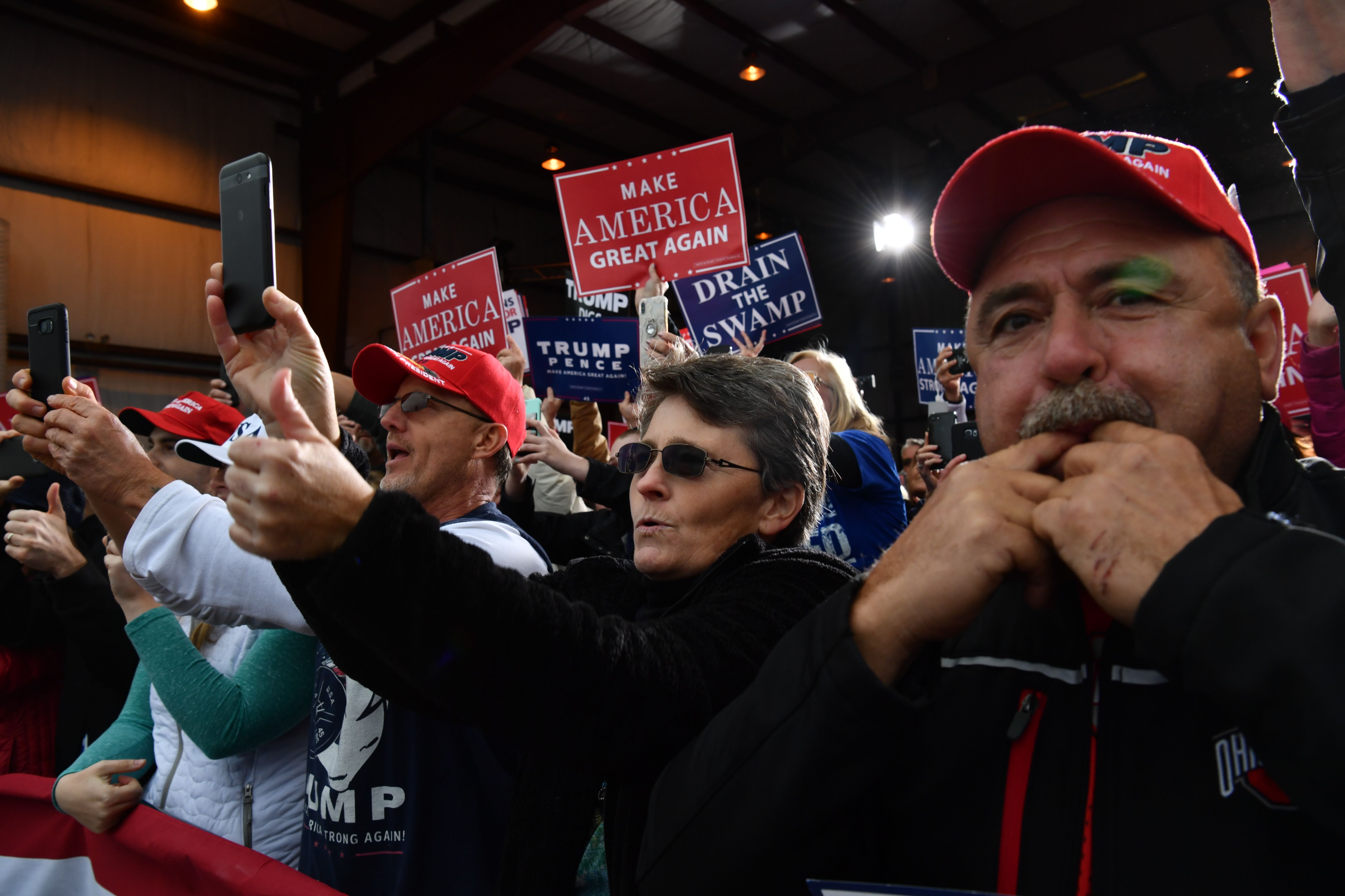 People cheer as President Donald Trump arrives to speak at a campaign rally at the Huntington Tri-State Airport, on November 2nd, 2018, in Huntington, West Virginia.