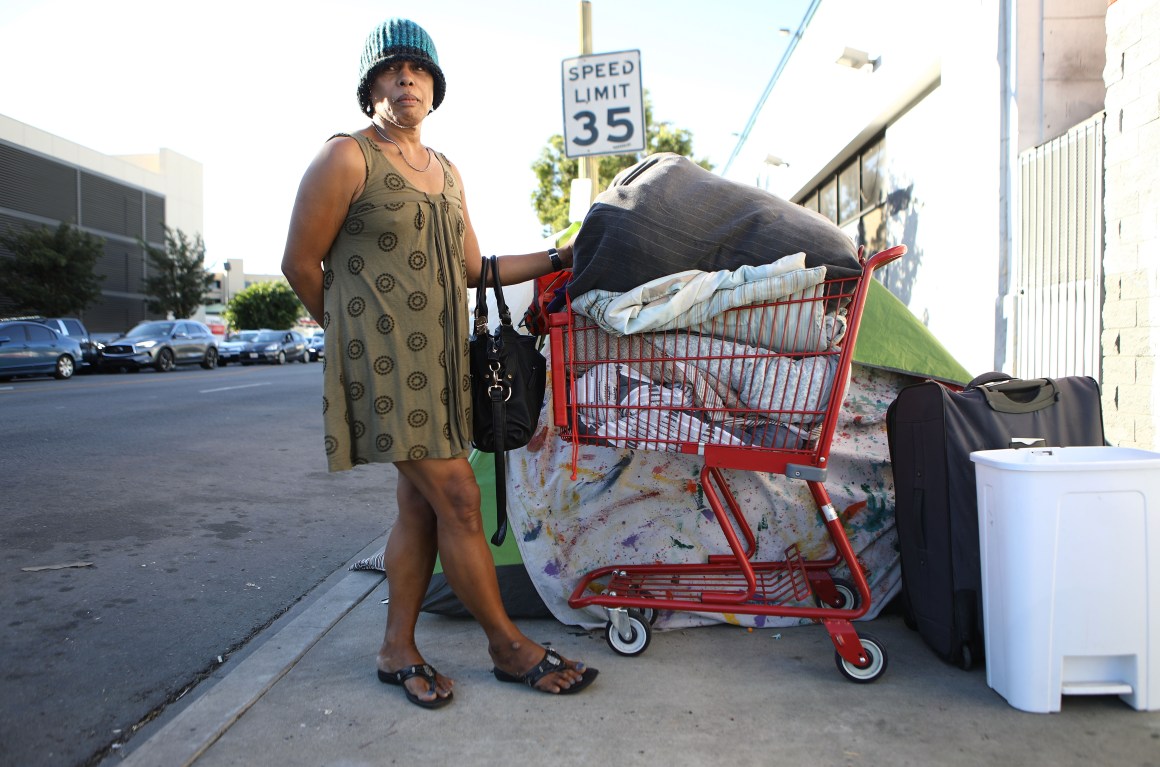 An unnamed homeless woman poses with her belongings on November 2nd, 2018, in Los Angeles, California.