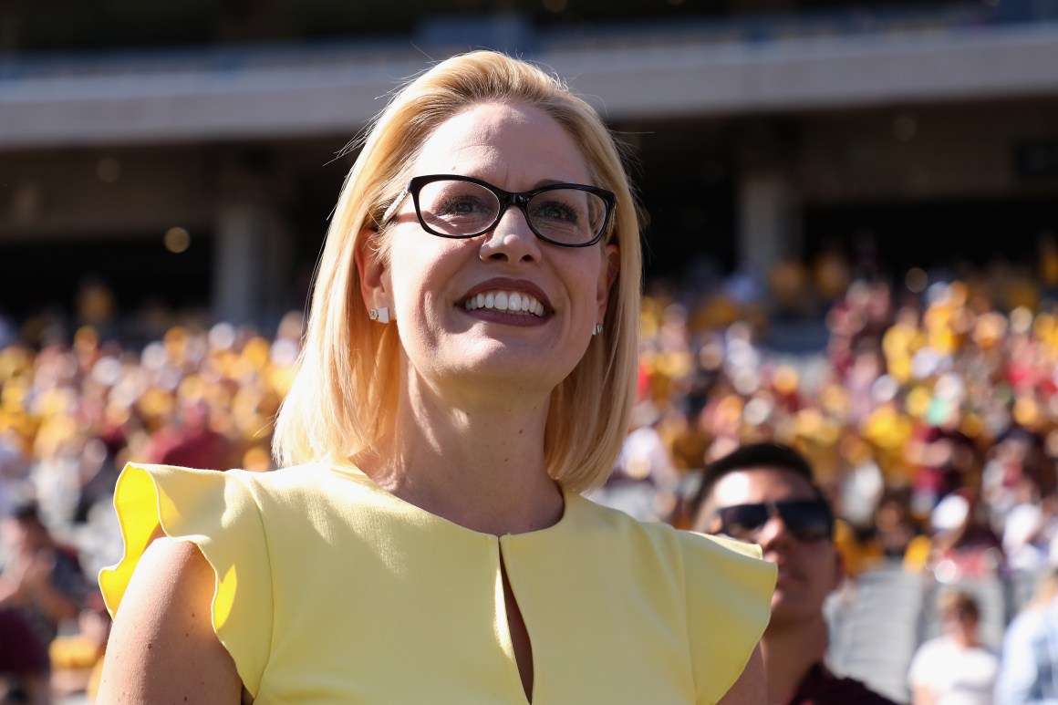 Democrat U.S. Senate candidate Kyrsten Sinema participates in the pregame coin toss before the game between the Utah Utes and the Arizona State Sun Devils at Sun Devil Stadium on November 3rd, 2018, in Tempe, Arizona.