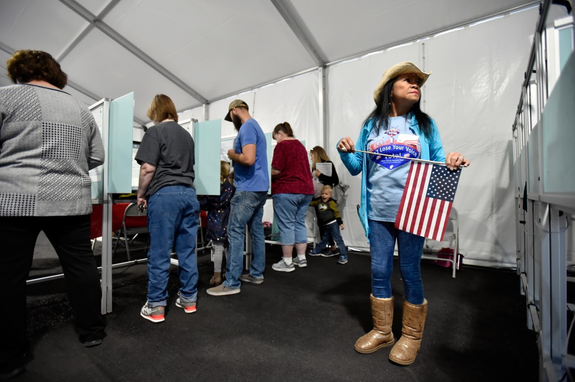 Election worker Leah Barney (right) watches over voters as they cast their ballots on November 6th, 2018, in Las Vegas, Nevada.