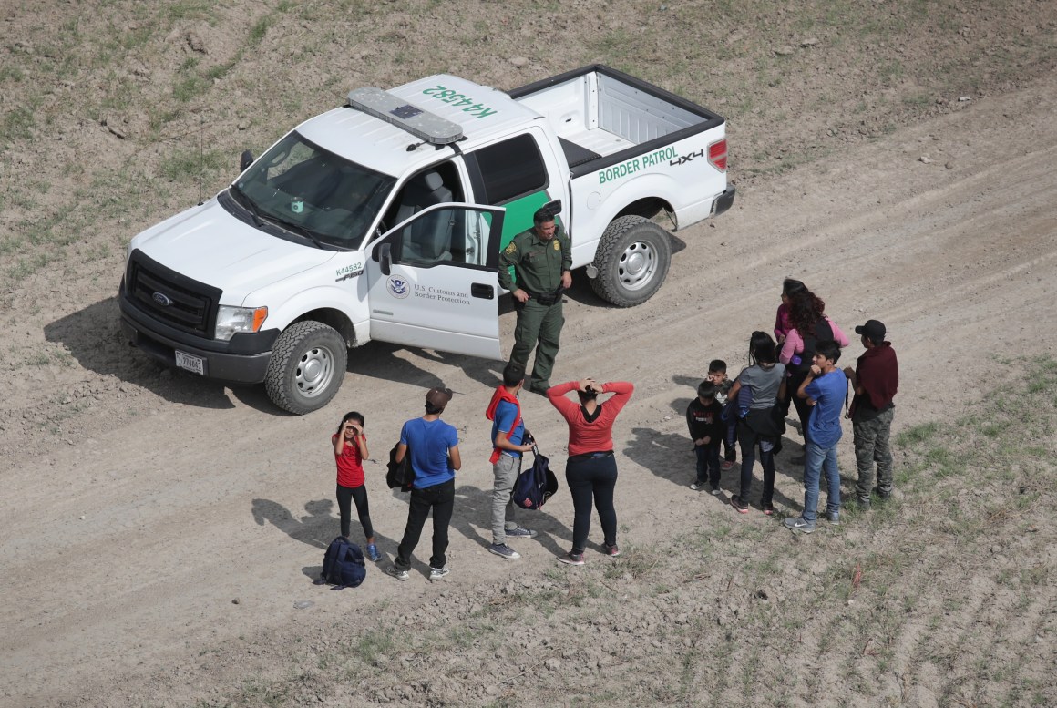 Asylum seekers turn themselves in to a U.S. Border Patrol agent after crossing from Mexico into the United States on November 7th, 2018, in Mission, Texas.