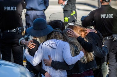 Friends hug outside the Los Robles Medical Center in Thousands Oaks, California, on November 8th, 2018, as they pay tribute to Ventura Country Sheriff's Sergeant Ron Helus, who was killed in a shooting at Borderline Bar & Grill the night before.