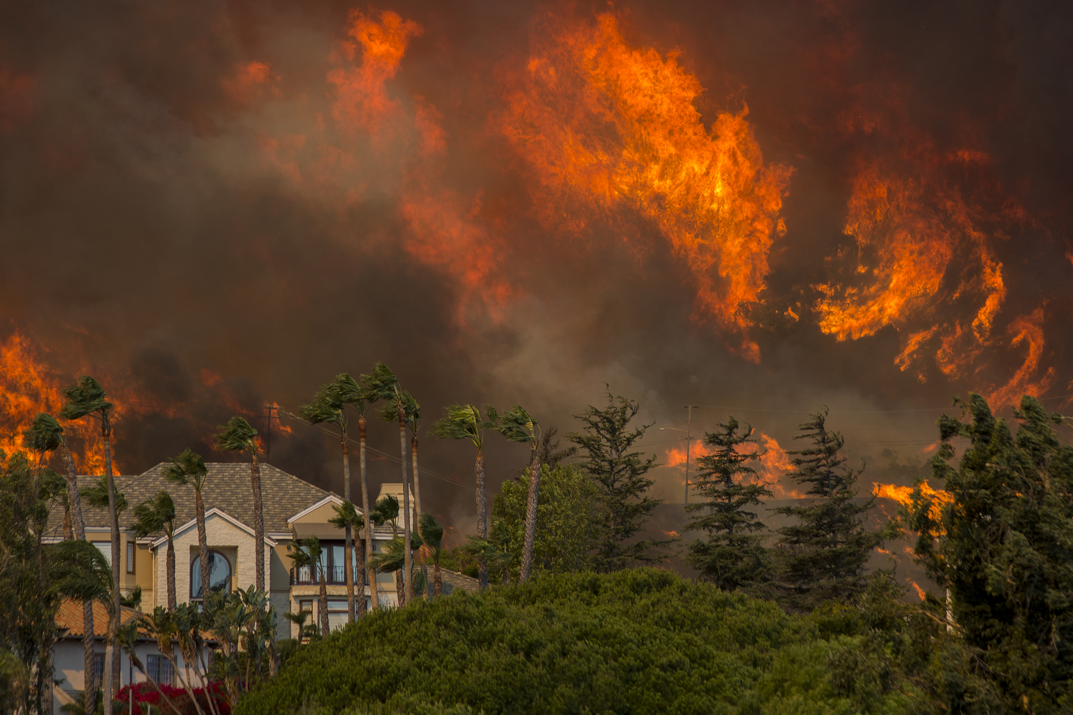 The Woolsey fire approaches homes on November 9th, 2018, in Malibu, California.