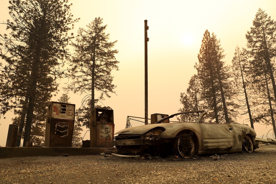 A burned out car sits next gas pumps at a gas station that was destroyed by the Camp Fire on November 11th, 2018, near Parkhill, California.