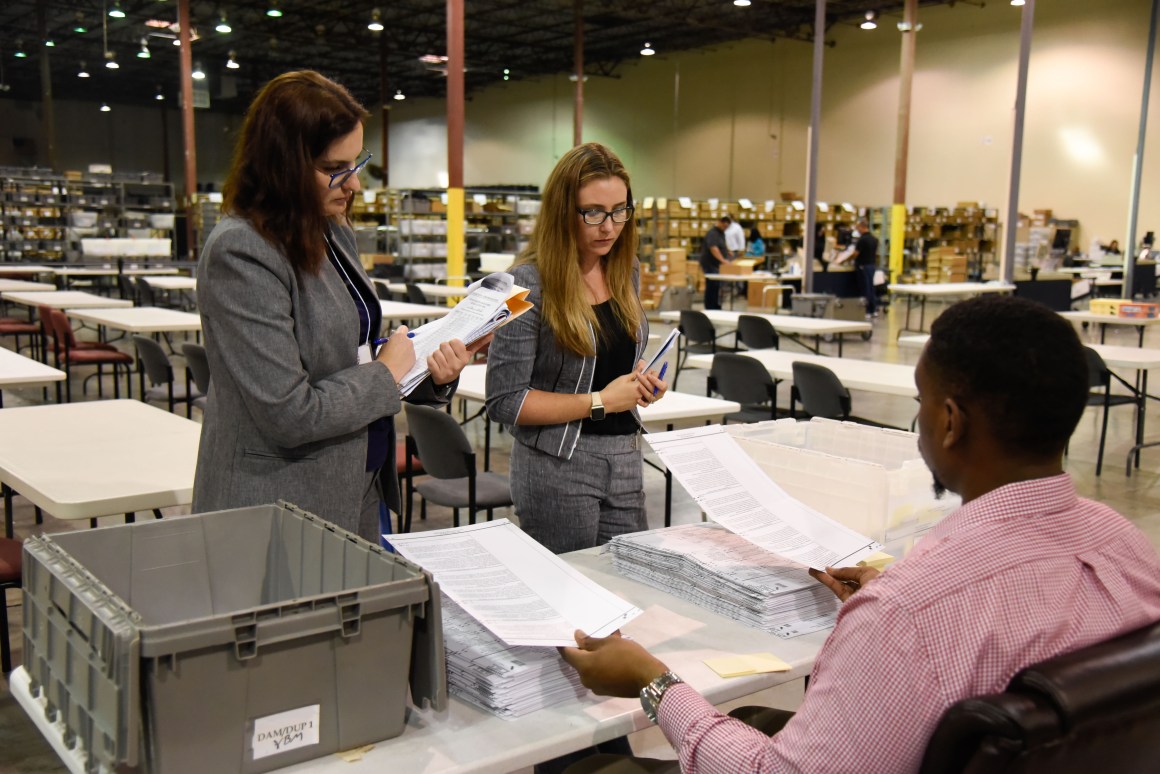 Attorneys oversee the ballot process at the Palm Beach County Supervisor of Elections Warehouse on November 15th, 2018, in West Palm Beach, Florida. Final results have yet to be declared in multiple races across the country following last week's mid-term elections, with tense recounts underway in Florida.