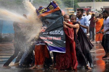 Police fire tear gas and use water cannons to disperse Sinhala extremist monks from Bodu Bala Sena on November 19th, 2018, in Colombo, Sri Lanka. The monks came to meet with Sri Lanka's president to hand over a message calling for the release of BBS General Secretary Galagoda Aththe Gnanasara Thera, who was sentenced to six years in prison. Sri Lanka's president later apologized for the severe treatment of the protesters.