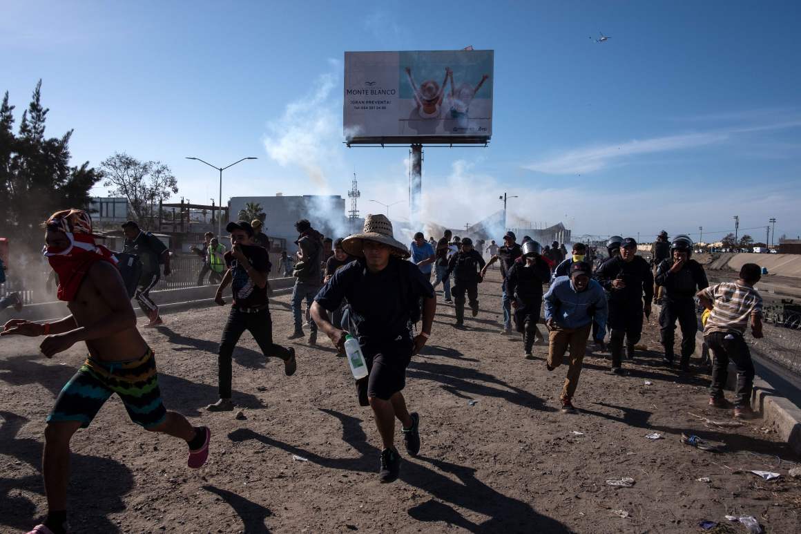 Central American migrants (mostly Hondurans) run along the Tijuana River near the El Chaparral border crossing in Tijuana, Baja California State, Mexico, near the U.S.–Mexico border, after the U.S. border patrol threw tear gas to disperse them after an alleged verbal dispute, on November 25th, 2018.