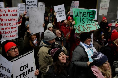 Educators from the Acero charter school network hold signs as they protest during a strike outside Chicago Public Schools headquarters on December 5th, 2018, in Chicago, Illinois. Teachers are asking for smaller class sizes, fair pay, and better resources to continue teaching the more than 7,000 students who attend Acero schools.