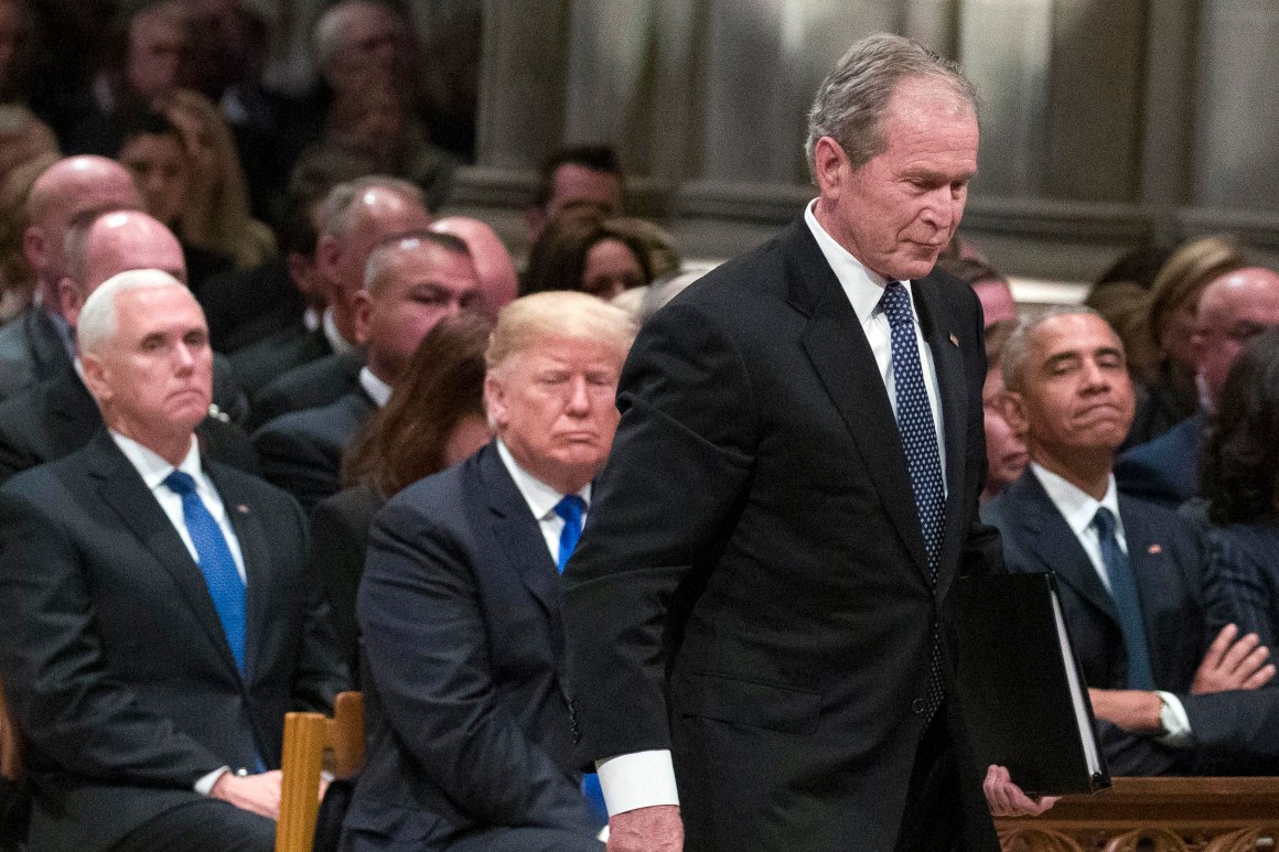 Former President George W. Bush walks past President Donald Trump to speak during the state funeral for his father, George H.W. Bush, at the National Cathedral on December 5th, 2018, in Washington, D.C.