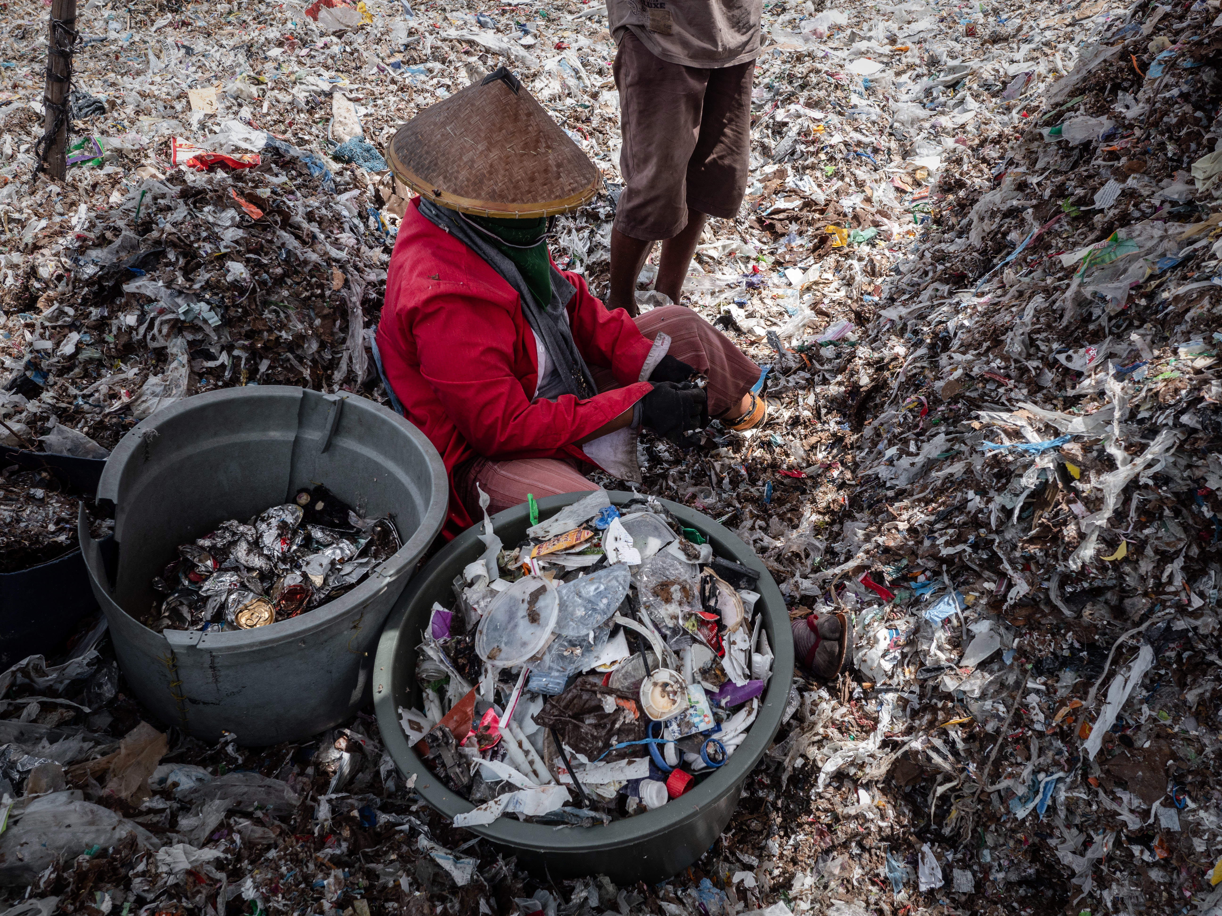 A woman collecting plastic to recycle at a plastic waste dump in Mojokerto on December 5th, 2018, in Mojokerto, East Java, Indonesia. Indonesia's second-largest city of Surabaya has recently been shortlisted by the Guangzhou Institute for Urban Innovation as one of the most sustainable cities among 900 other cities with its participatory waste management system and involvement of residents in various city projects such as the the 