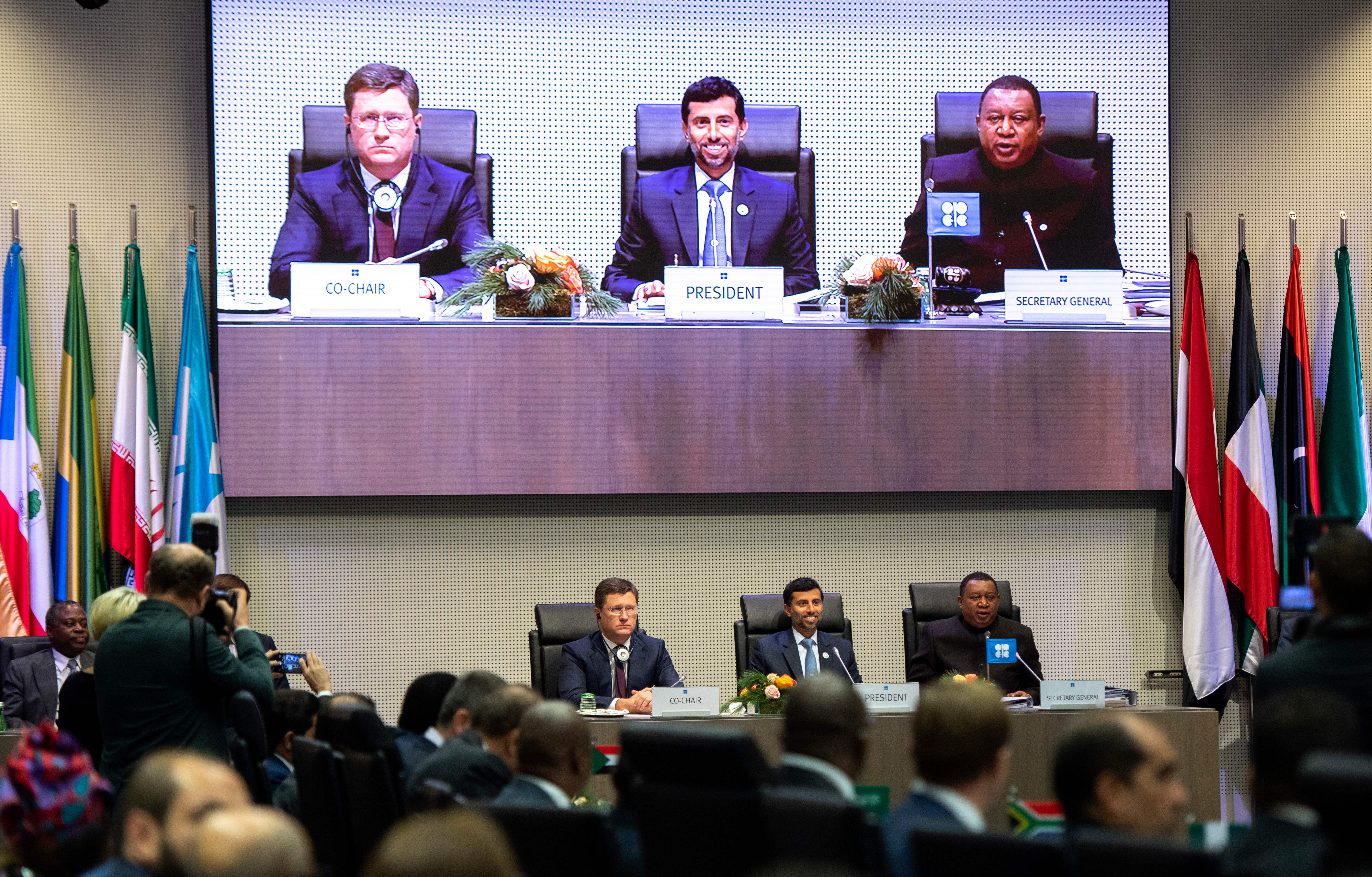 Russian Minister of Energy Alexander Novak, President of OPEC and United Arab Emirates Energy Minister Suhail al-Mazrouei, and OPEC Secretary General Mohammed Sanusi Barkindo of Nigeria speak during a ministerial-level meeting with OPEC members and non-members during the 175th OPEC Conference on December 7th, 2018, in Vienna, Austria. OPEC is aiming to reduce production of oil and raise prices.