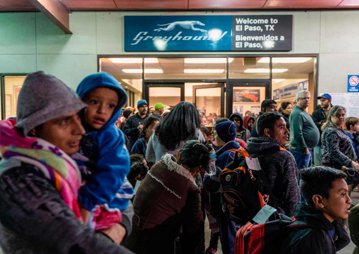 Asylum seekers stand at the Greyhound bus station in downtown El Paso, Texas, late on December 23rd, 2018.