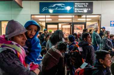 Asylum seekers stand at the Greyhound bus station in downtown El Paso, Texas, late on December 23rd, 2018.