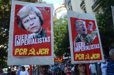 Communist demonstrators hold up posters decrying United Kingdom Prime Minister Theresa May and U.S. President Donald Trump as imperialists in Spanish in Buenos Aires on November 30th, 2018.